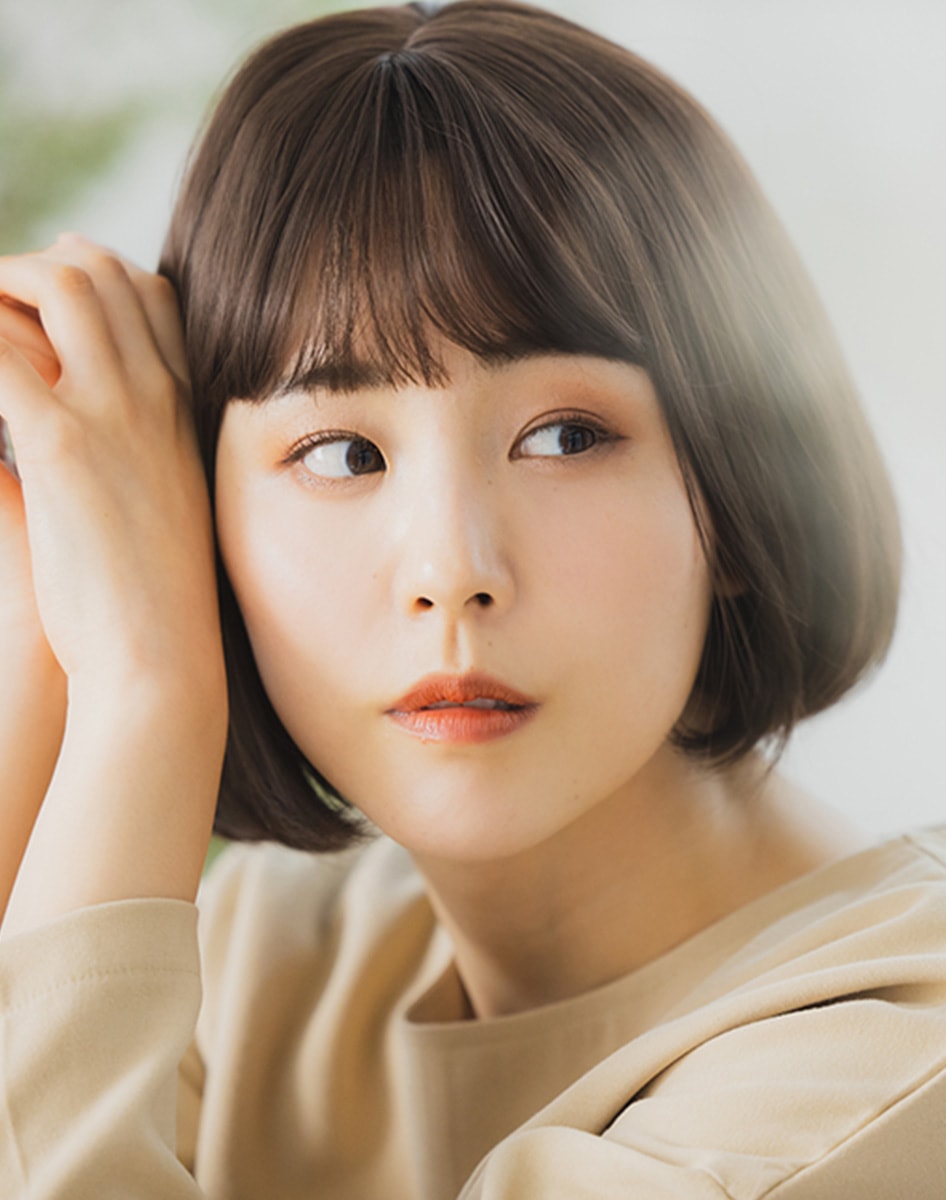 髪に手を添える女性